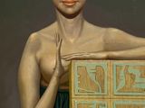 a painting of a woman holding a box with an alien face on it