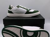 a close up of a pair of green and white sneakers