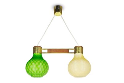 two green and white glass lamps hanging from a brass frame