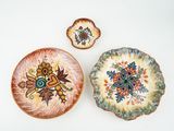 three plates with different designs on them on a table