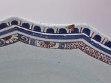 a close up of a decorative blue and white plate