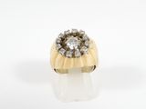 a close up of a gold ring with diamonds on a white surface
