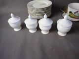 a lot of white dishes and cups on the table