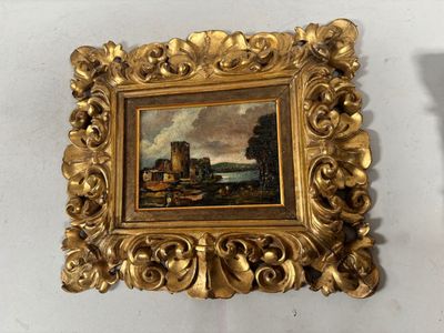 une photo d'un tableau accroché au mur à côté d'une bougie