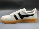 a close up of a white and black sneaker on a gray surface