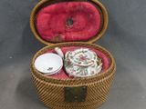 a wicker basket with a tea set inside of it