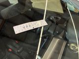 a sticker on the windshield of a car with a ticket attached to it