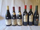 several bottles of wine are lined up on a table