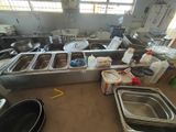 a large kitchen with a lot of dishes on the counter