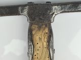 a close up of a hammer on a white surface