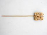 an image of a gold stick with a flower design on it