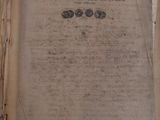 an old book with writing on it sitting on a table