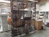 a large metal cage that is in the middle of a room