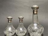 three glass decanters sitting next to each other on a table