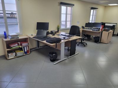 an image of an office with two computers and a desk