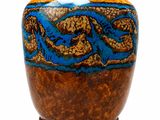 a brown and blue vase on a wooden stand
