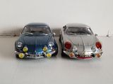 two toy cars sitting next to each other on a table