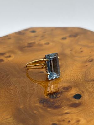 an image of a ring with a blue topaz stone in it