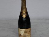 a bottle of champagne sitting on a marble counter top