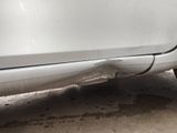 a white car that is parked on the side of the road