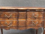 an image of a wooden chest of drawers on a table