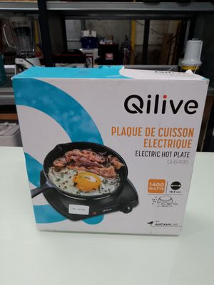 the box of the electric skillet is sitting on the table