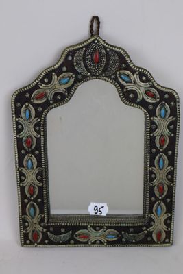 a close up of a mirror on a wall with a tag on it