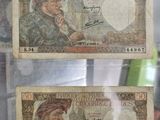 two old bank notes in a glass case