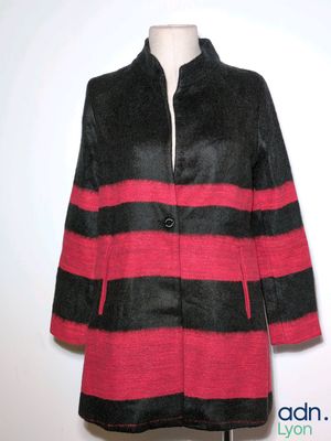 a black and red coat on a mannequin stand