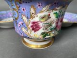 two cups and saucers sitting on a table