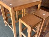 three stools and a table in a room
