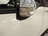 a close up of the side view mirror of a white car