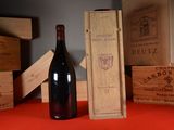 a bottle of wine sitting on a table next to a box of wine