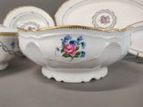 a white bowl with blue and pink flowers on it