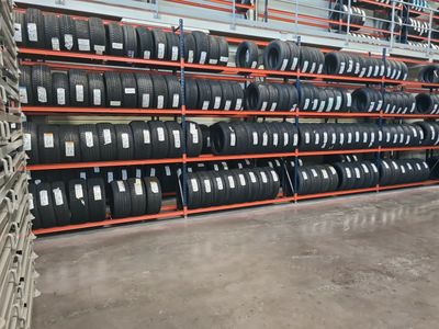 many tires stacked on the shelves in the warehouse