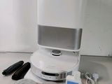 an image of a white speaker system with various accessories