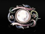 a close up of a broochle with a woman ' s face in it
