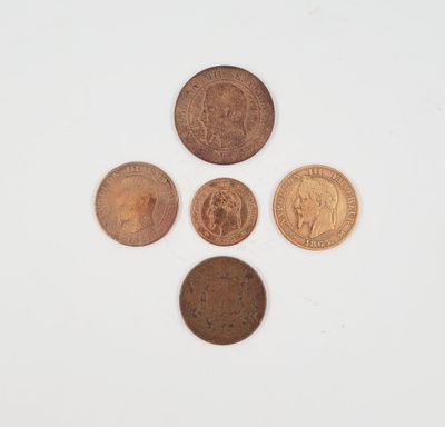 a group of five different coins sitting on top of a white surface