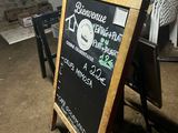a chalk board with a sign on it in a room