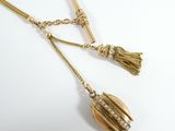 an image of a pair of earrings with tassels hanging from them