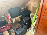 a room with a lot of suitcases and a radiator