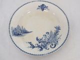 a blue and white plate with a picture of a boy on it
