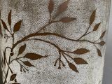 a close up of a glass with a flower design on it