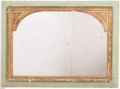a mirror with a gold frame on a white wall