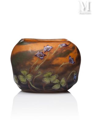 a glass vase with flowers painted on it on a white surface