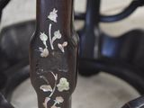 a close up view of a wooden chair with a floral design on it