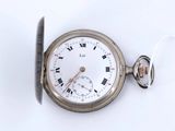 a silver pocket watch with roman numerals on it