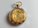 an image of a gold pocket watch on a white surface