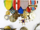 many medals and medals on display on a white surface