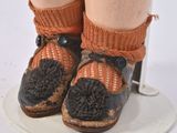 a close up of a doll ' s legs and shoes